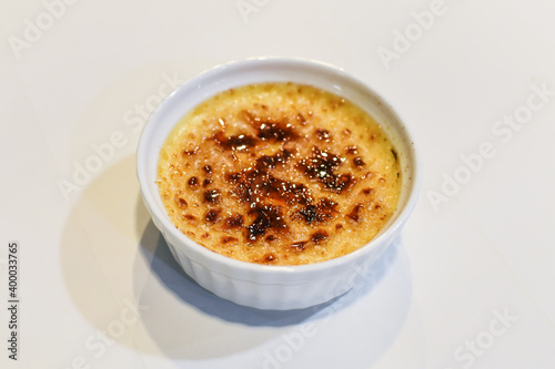 Caramelized crème brulee in a white cup