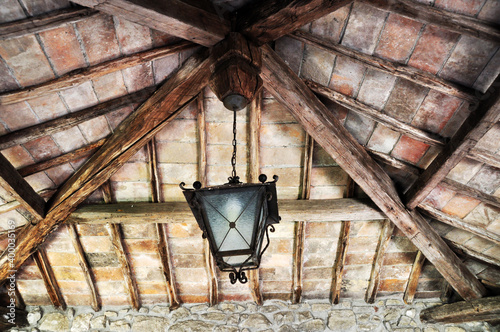 Old metal lamp. The lamp is suspended from the ceiling on a chain.