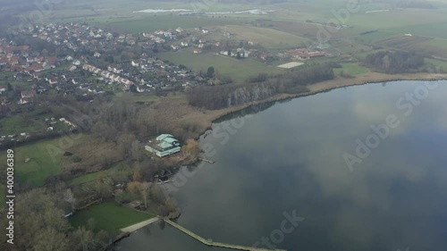 Drone aerial of the typical german village Seeburg located at the Seeburger See on a beautiful Sunday morning. A scenic winter and autumn landscape inviting for a hike with the family in Germany. photo