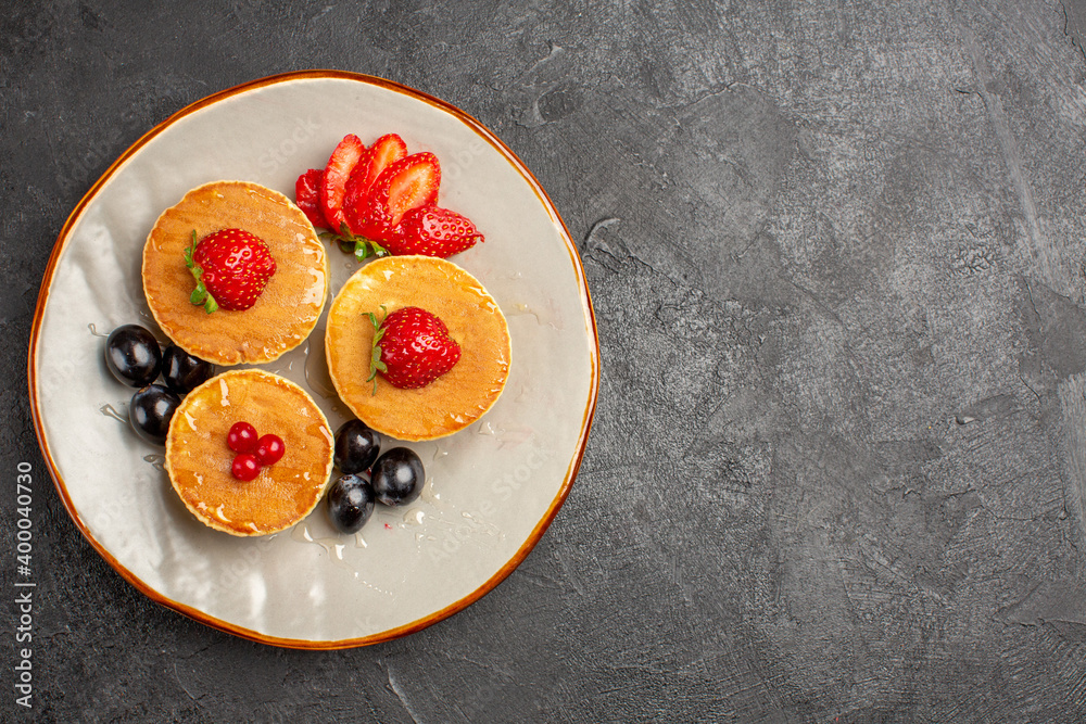 top view yummy pancakes little formed with fruits on the dark background fruit cake pie top view yummy pancakes little formed with fruits on the dark background fruit cake pie