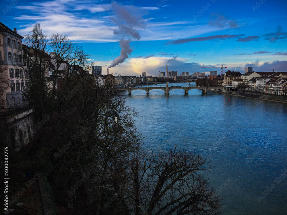 Beautiful winter afternoon with a view of the River Rhine in Basel, Switzerland. Blue Sky with Clouds