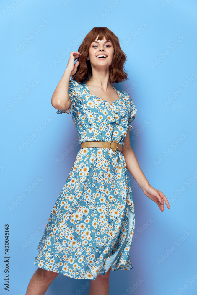 Woman in fashionable dress straightens hair with hand joy smil Woman in fashionable dress straightens hair with hand joy smil