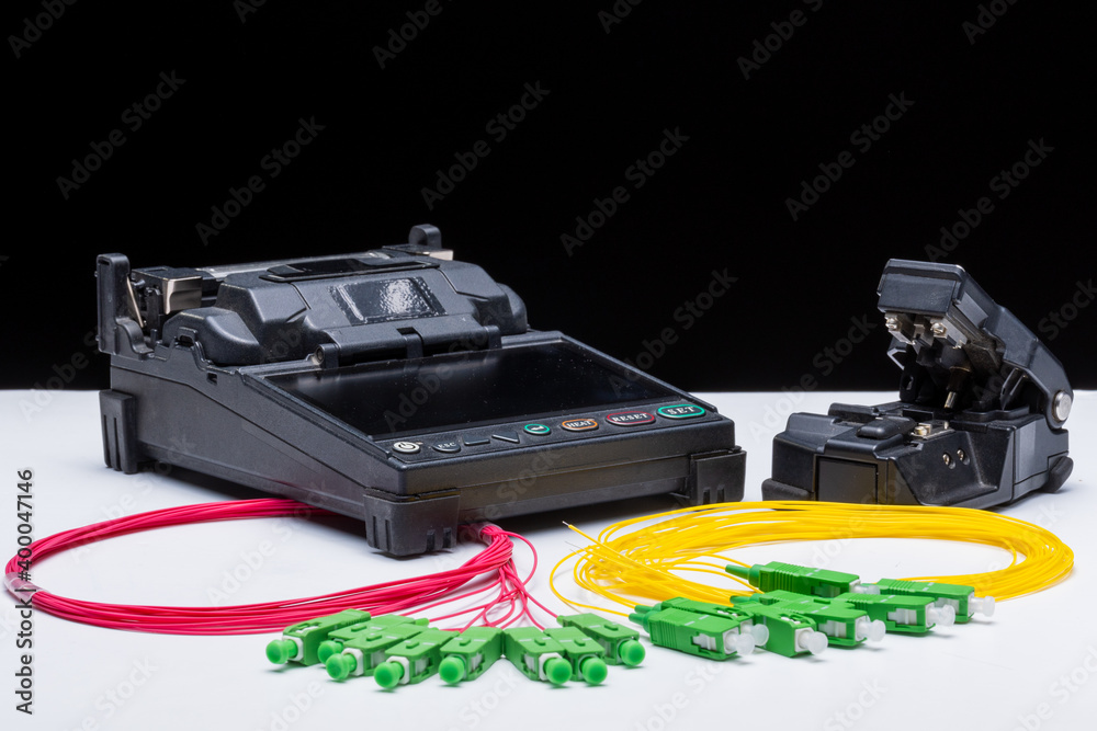 short sections of red optical cable with green connectors on a white background short sections of red optical cable with green connectors on a white background
