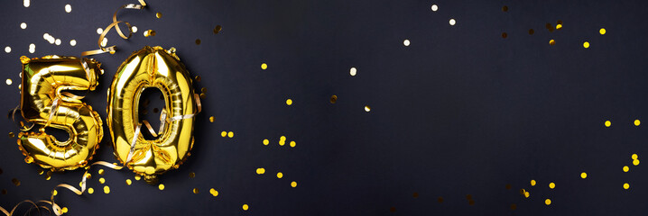 Gold foil balloon number, digit fifty. Birthday greeting card with inscription 50. Anniversary celebration event. Banner. Golden numeral, black background. Numerical digit, light bokeh, glitter.