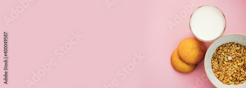 cookies milk muesli on a pink background. top view