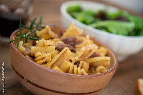 pasta and beans in a bowl on a wooden background, typical dish of Italian food