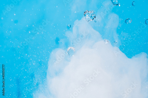 Water drop. Chemical reaction with boiling swirling water splashes, jumping drops with a large release of heat and gas vapor. Water splashing is a physical phenomenon