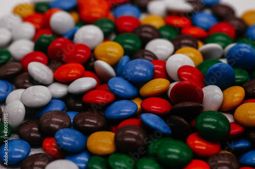 background of small round multicolored sweets close-up