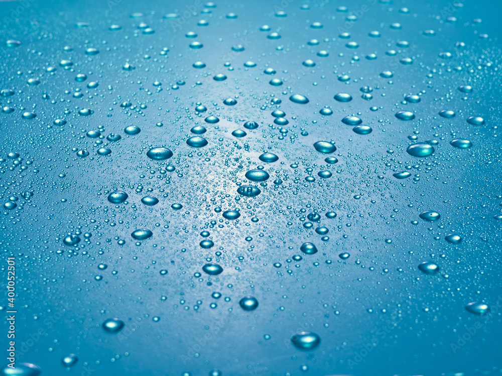 Random water drops on the blue PVC surface