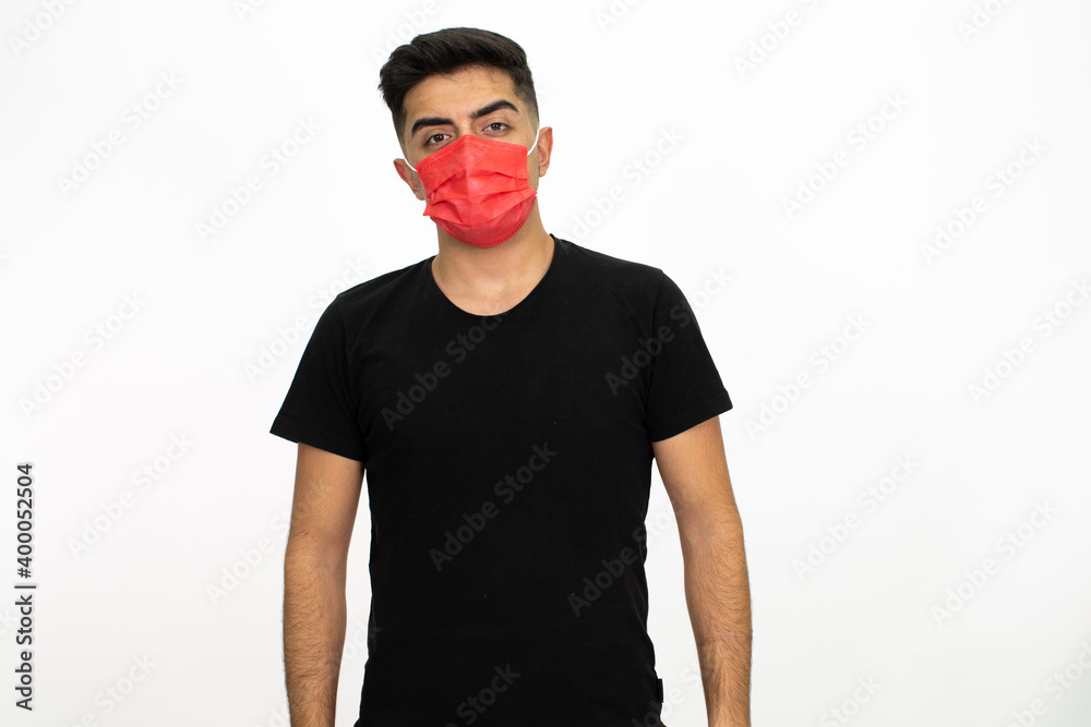 Young male model wearing a red medical face mask. He is wearing a black shirt. Isolated image and white background. Young male model wearing a red medical face mask. He is wearing a black shirt. Isolated image and white background.