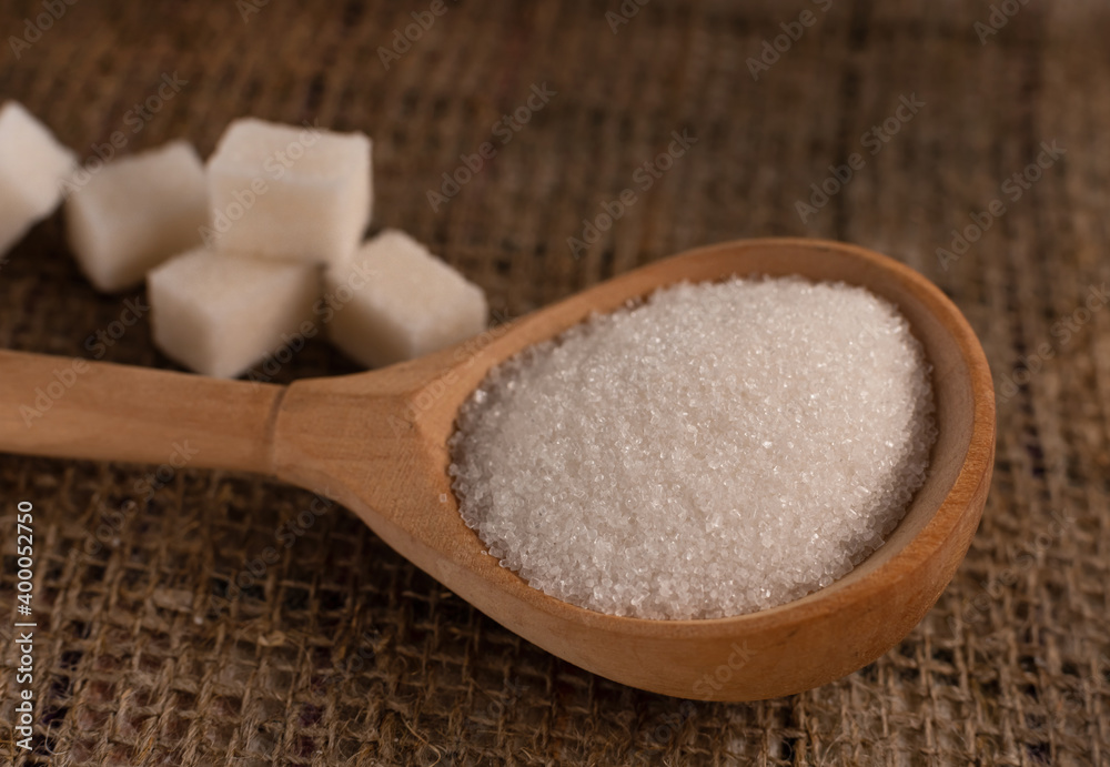 Pieces of lump sugar on burlap. granulated sugar close-up. Refined sugar. Sugar Pieces of lump sugar on burlap. granulated sugar close-up. Refined sugar. Sugar
