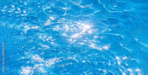 texture of blue water in the pool. a bright Sunny day in the summer. banner