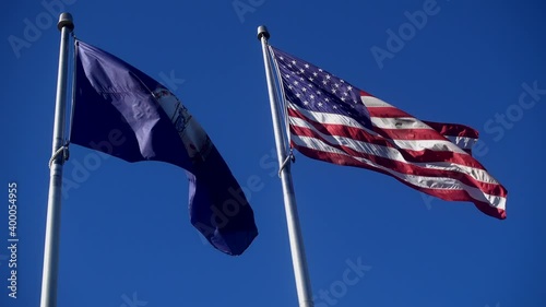 Waving Flags of Virginia and USA on blue sky background.