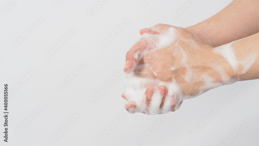 Fototapeta premium Hand wash gesture with foaming hand soap on white background.copy space
