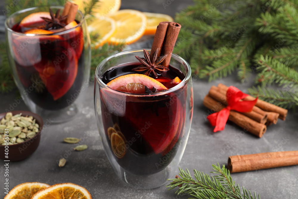 Aromatic mulled wine and ingredients on grey table, closeup Aromatic mulled wine and ingredients on grey table, closeup