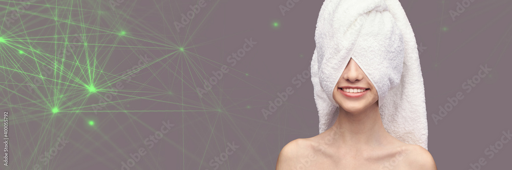 Obraz premium Young girl head in studio. Bathroom towel. Cosmetology concept. Skin care product. Unrecognised female portrait. Beauty smile. Tooth surgery. Medicine treatment. Grey background. Technology. Copyspace