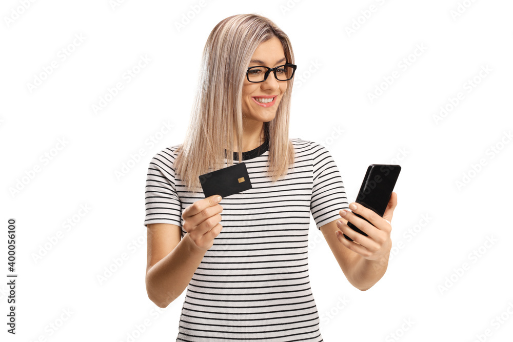 Young woman using a mobile phone and a credit card Young woman using a mobile phone and a credit card