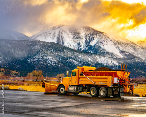 Image of a snow plow gearing up to plow the storm.