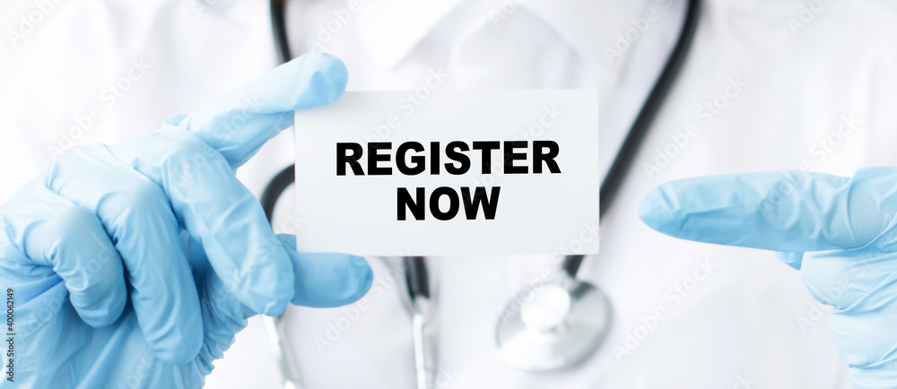 Register Now text on the card in the hands of a doctor, a close-up of hands in blue gloves and cards.