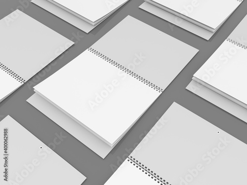 Quarter wall calendars with a 3 in 1 calendar block are staggered on the floor. Mockup. 3D rendering.