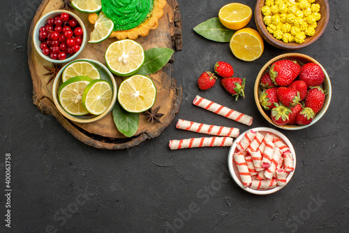 top view yummy creamy cake with candies and fruits on dark background sweet cookies biscuit