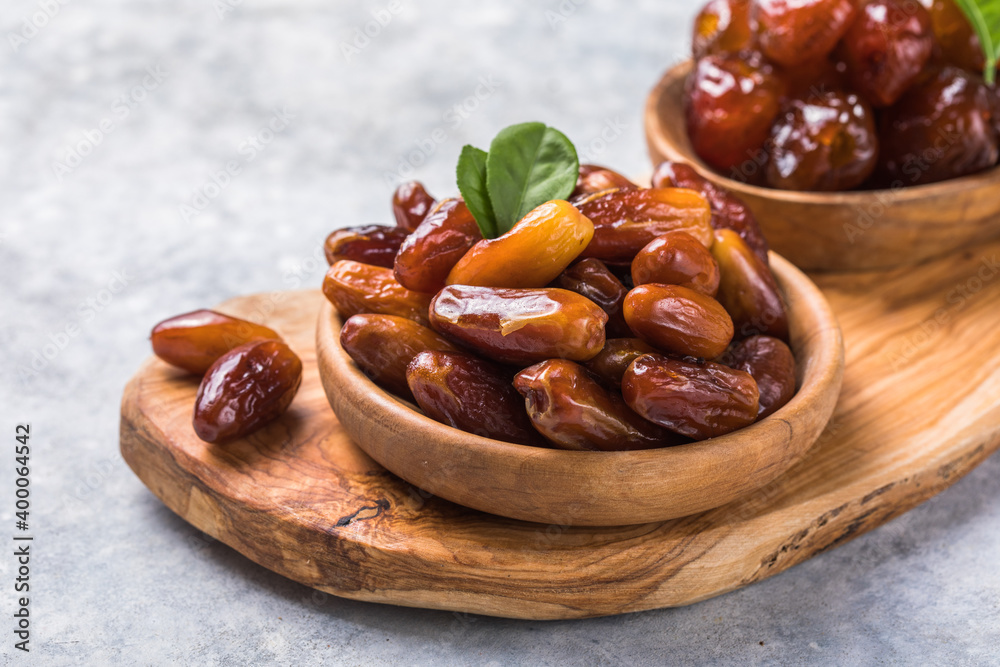 Dates or dattes palm fruit in wooden bowl is snack healthy.Creative layout made of dried dates. Flat lay. Food concept. Fruits dates. Dates Palm fruit isolated on white. Dried fruits. Healthy diet. Dates or dattes palm fruit in wooden bowl is snack healthy.Creative layout made of dried dates. Flat lay. Food concept. Fruits dates. Dates Palm fruit isolated on white. Dried fruits. Healthy diet.