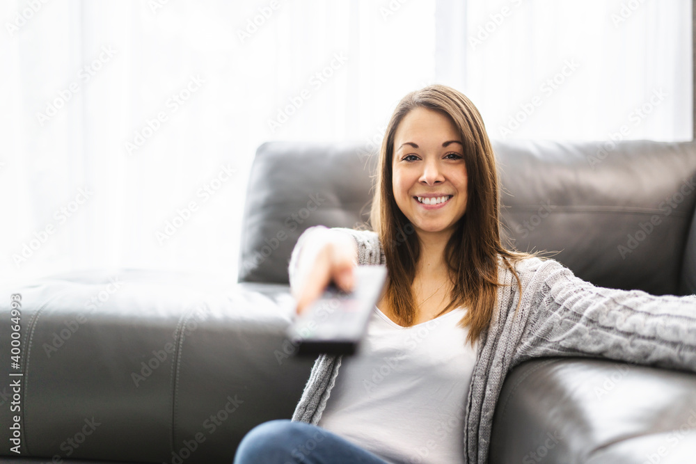 Young woman watching TV lying on the floor at home Young woman watching TV lying on the floor at home