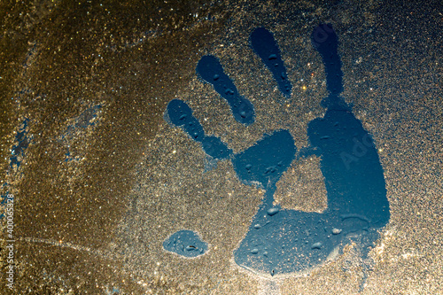 palm print on frozen glass
