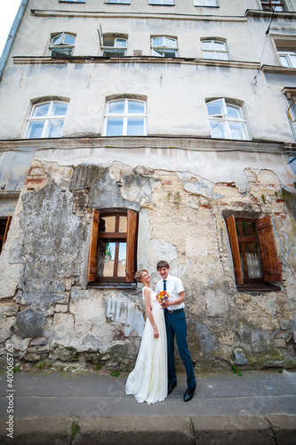 Bride and groom walking in old city © alipko