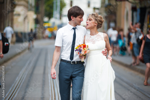 Bride and groom walking in old city