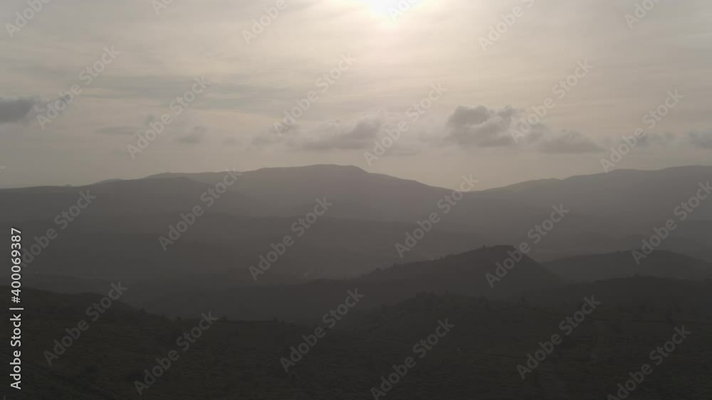 Drone shot flying through the Black mountain of Narbonne during the sunrise with a beautiful light with big windmill farm around Drone shot flying through the Black mountain of Narbonne during the sunrise with a beautiful light with big windmill farm around