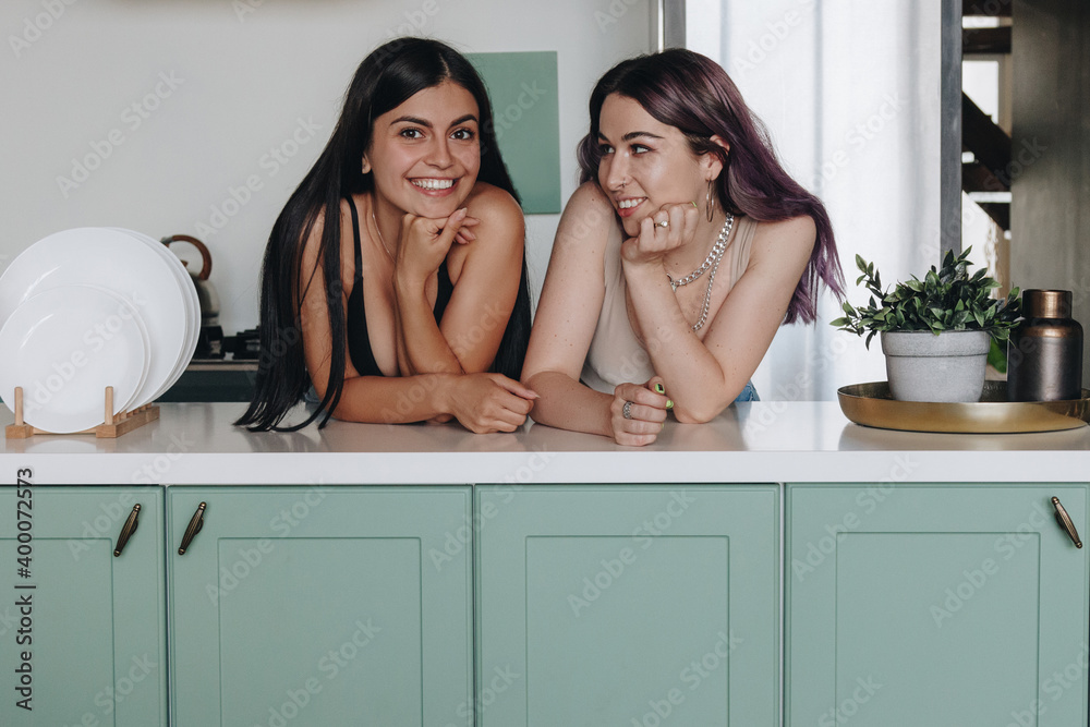 Lesbian couple in the kitchen Lesbian couple in the kitchen
