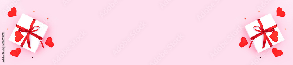 Background with gift, hearts and confetti with free space for text on pastel pink background, wide angle view. Flat lay, top view. Valentines day concept. Mother's Day concept. Banner.