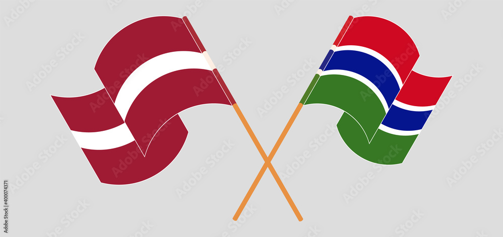 Crossed and waving flags of Latvia and the Gambia