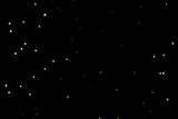 black background with yellow and gray glitter stars. Copyspace.