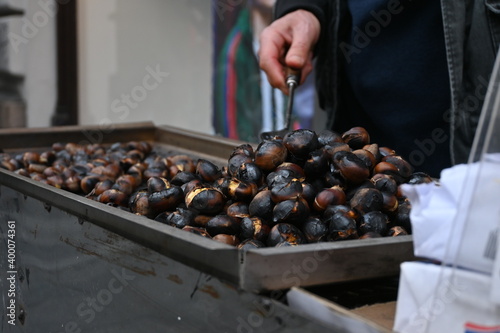 a man roasting chestnuts on a street