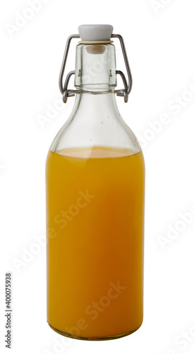 orange juice in glass bottle closed with reusable stopper isolated on white background