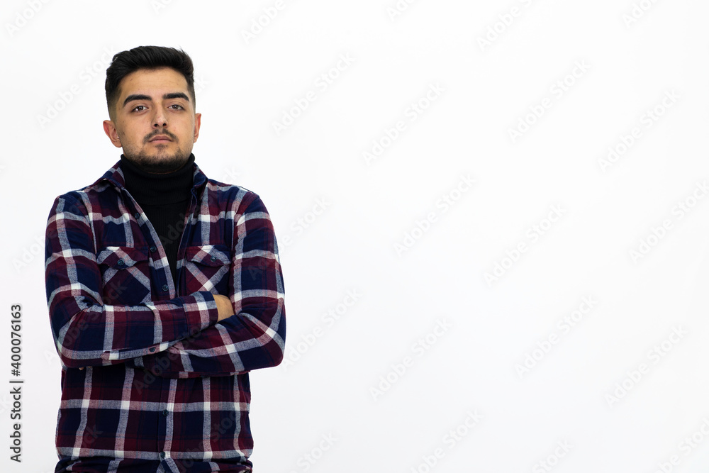 Fototapeta premium Young man wearing a dark striped shirt. He has a dirty beard White background. Isolated image. 