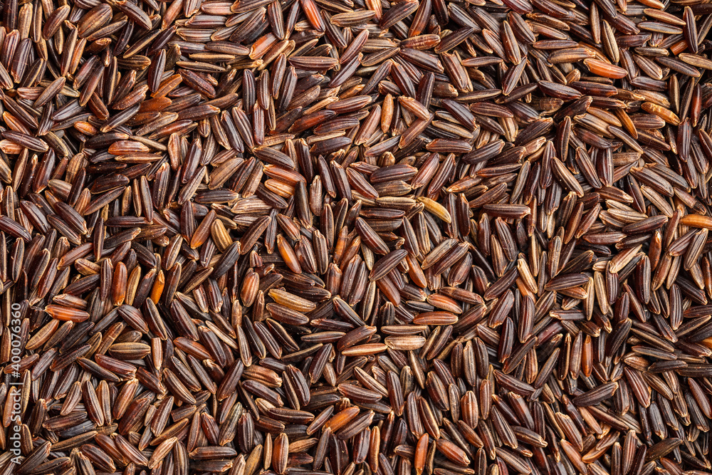 Uncooked red rice. Raw wild rice.