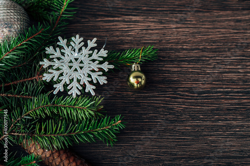 Christmas Tree Branches and Snowflakes on a Brown Background with CopySpace