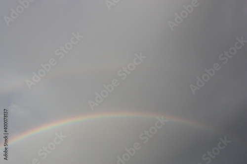 rainbow across the sky in bottom of photo