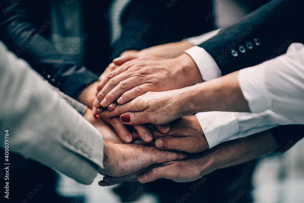 close up. a stack of hands. the concept of unity