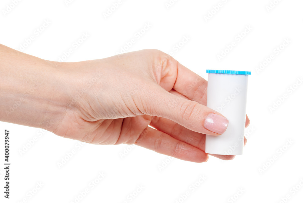 Hand with homeopathy bottle isolated on white background.