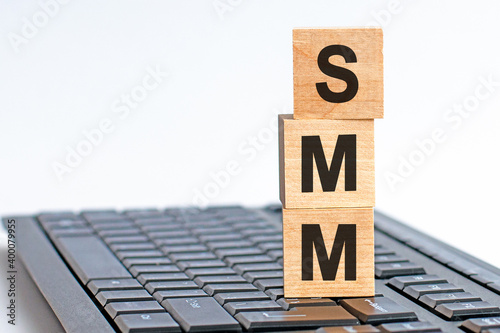 SMM - acronym from wooden blocks with letters, concept. SMM - Social Media Marketing photo