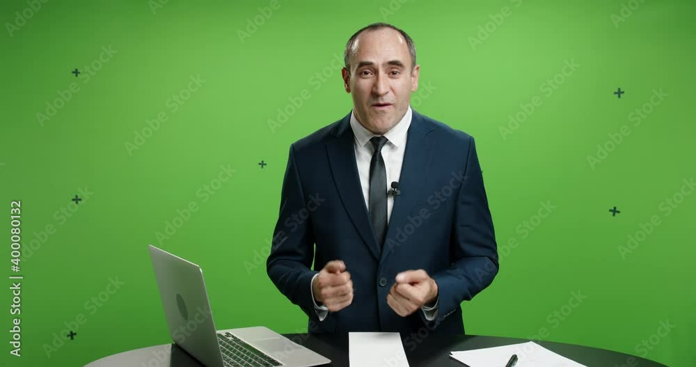 Male television anchor is talking about current news. Positive man gesturing while reporting on global events, green chroma key template 4k footage Male television anchor is talking about current news. Positive man gesturing while reporting on global events, green chroma key template 4k footage