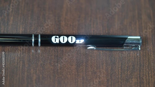 Laser engraving on metal  black pen. Modern industrial technologies. Word Good luck