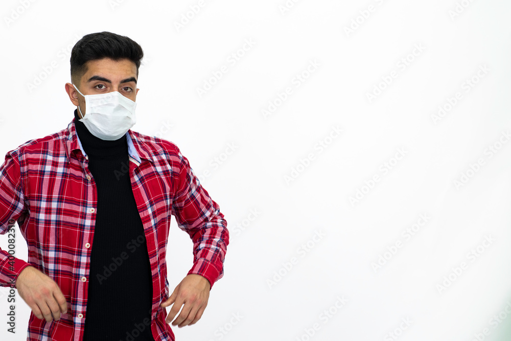 Young man wearing a medical mask. He wears a striped red shirt. Young man wearing a medical mask. He wears a striped red shirt.