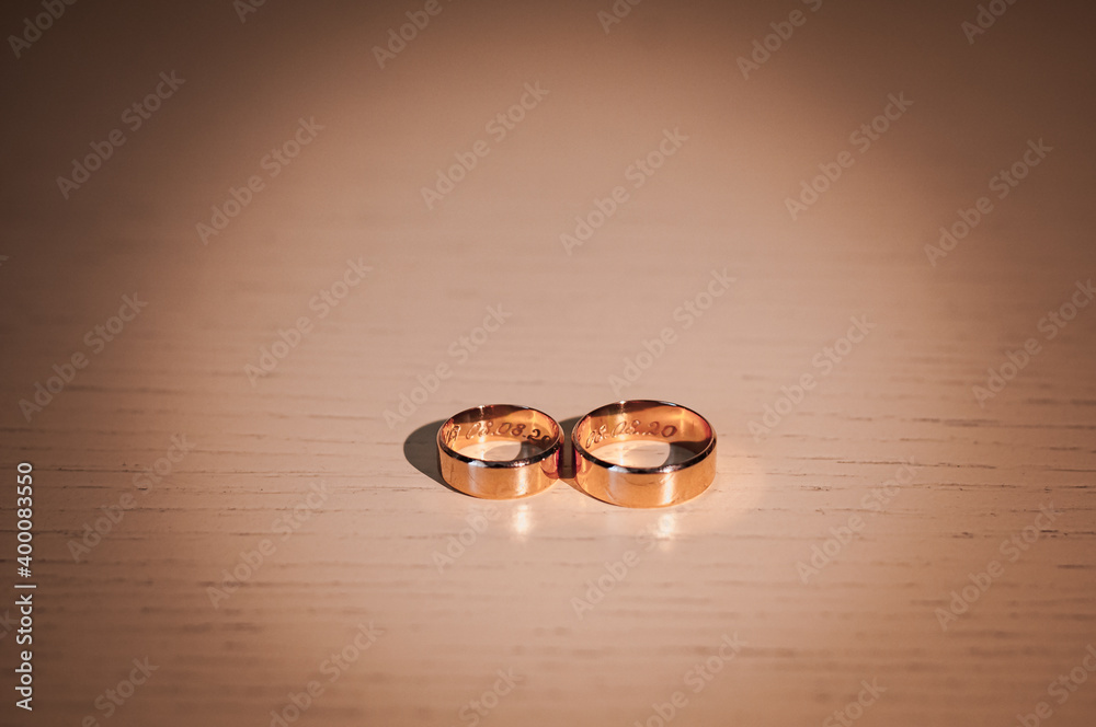 Gold wedding rings on the table. Wedding accessories Gold wedding rings on the table. Wedding accessories