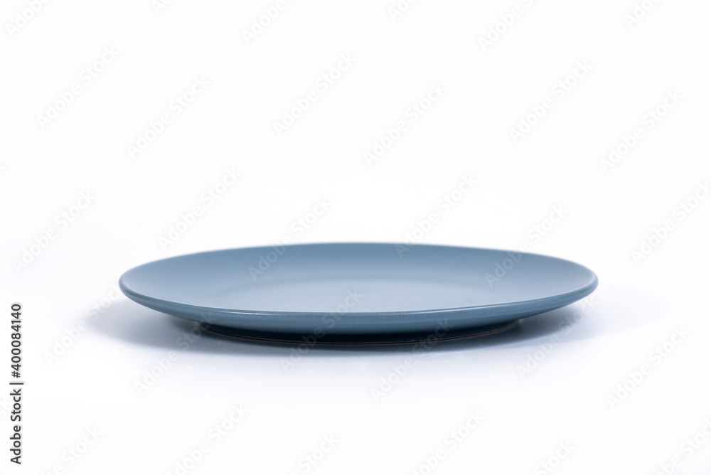 Empty Navy Blue plate isolated on white background side view, selective focus Empty Navy Blue plate isolated on white background side view, selective focus