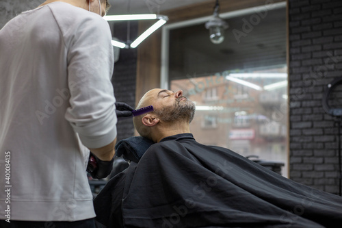 Man in the barber shop. Beard trimming